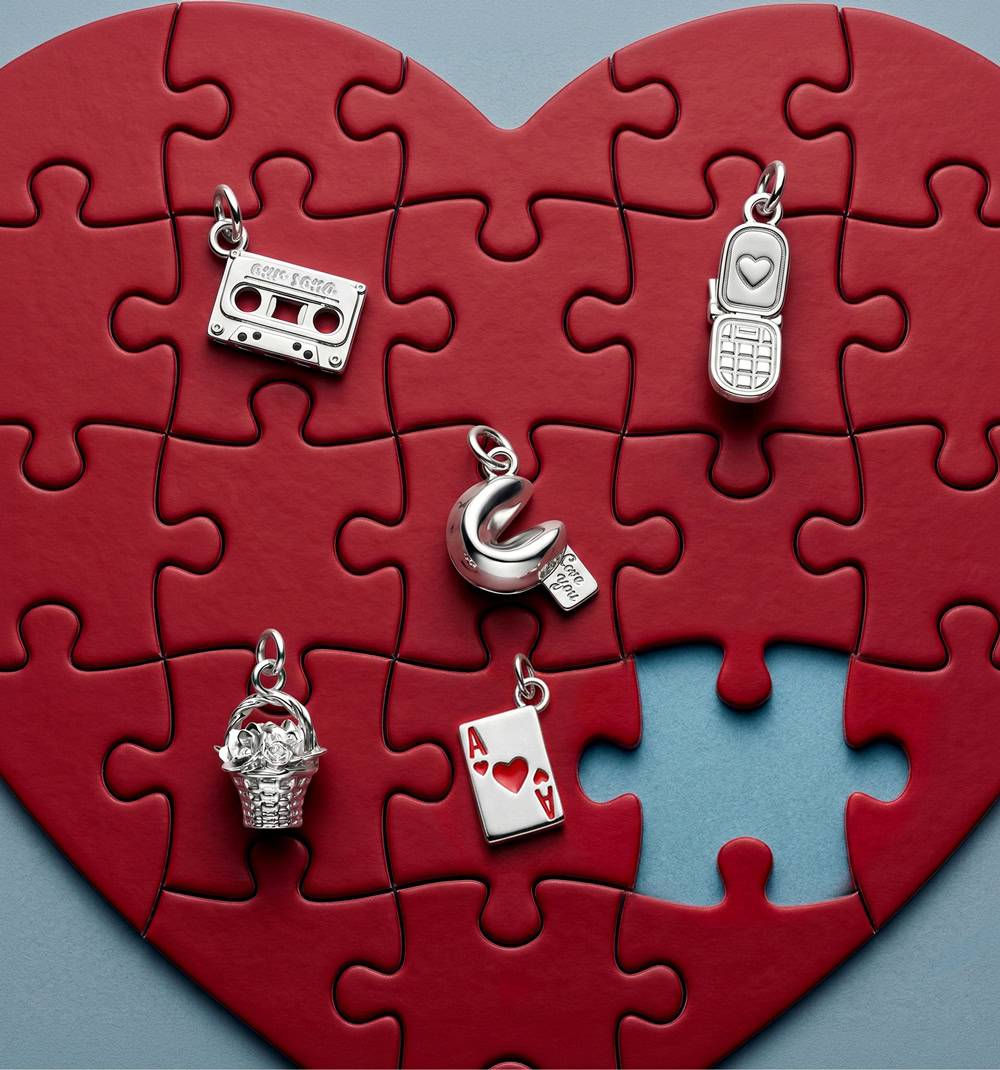 The Chapters Bracelet charms on a puzzle heart